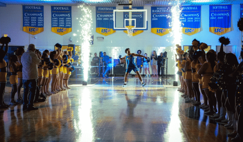 Photo by: Edward Green Sophomore basketball player, David Oriaku throws a javelina t-shirt to pump up the crowd during Homecoming week at the Javelina Madness event.