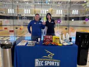 Rec staff handing out hot cocoa to students